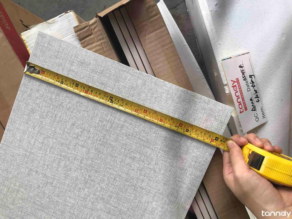 Inspector measuring a tile with a tape during Tanndy quality inspection